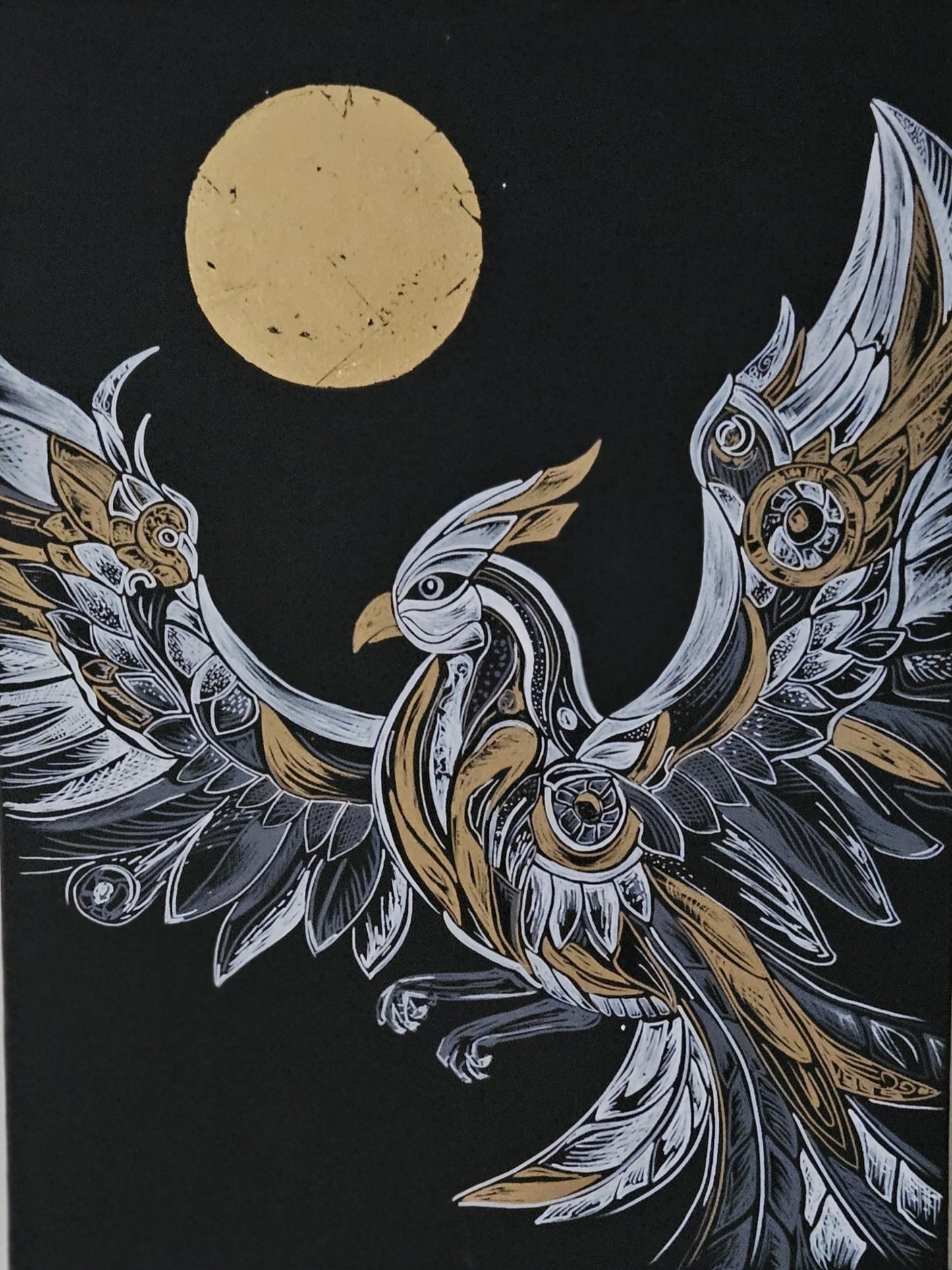 A black and gold abstract acrylic painting on canvas depicting a stylized bird or phoenix with outstretched wings against a dark background with a golden moon.