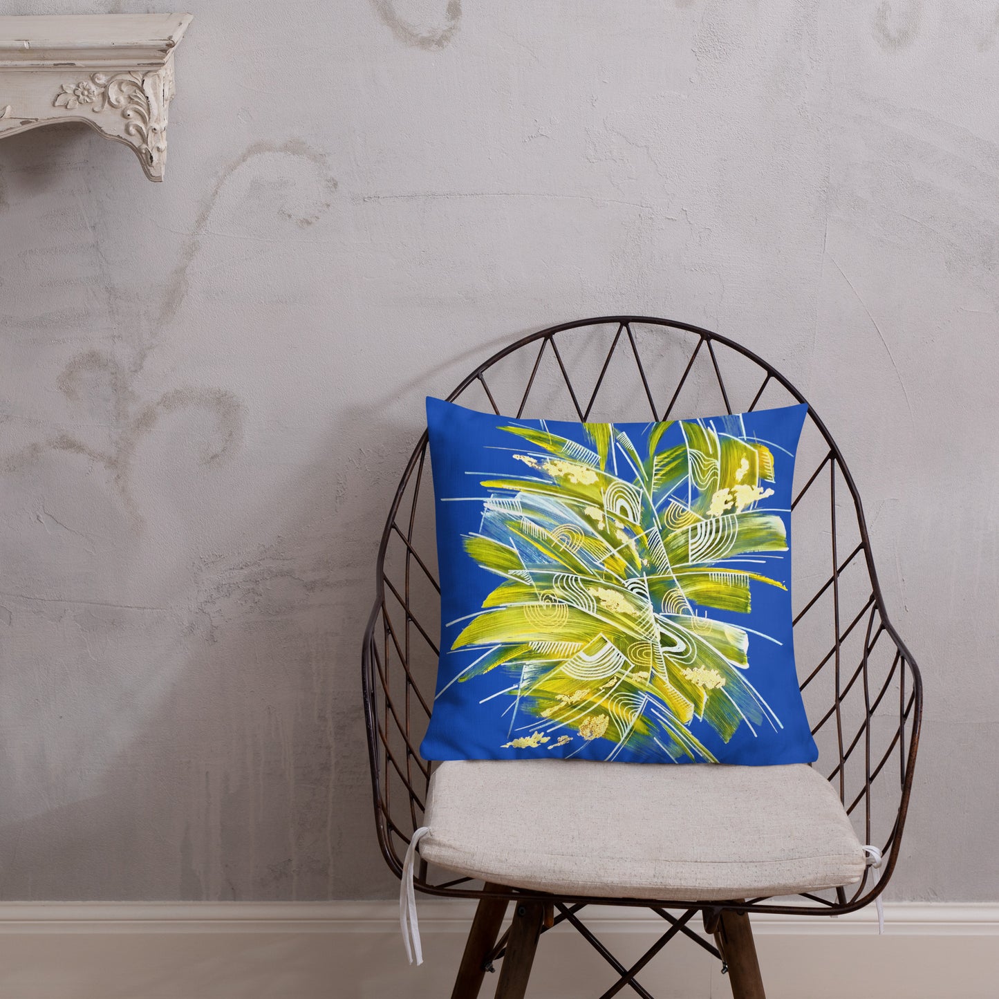 Decorative pillow with a tropical leaf design on a chair against a gray wall. High quality cushions UK. Lumbar cushion